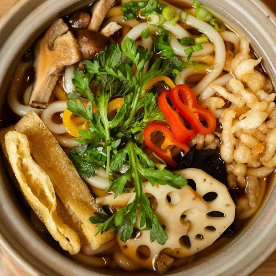 Niko Niko Sushi's udon noodle soup with mushrooms, lotus root, peppers, and fried tofu.